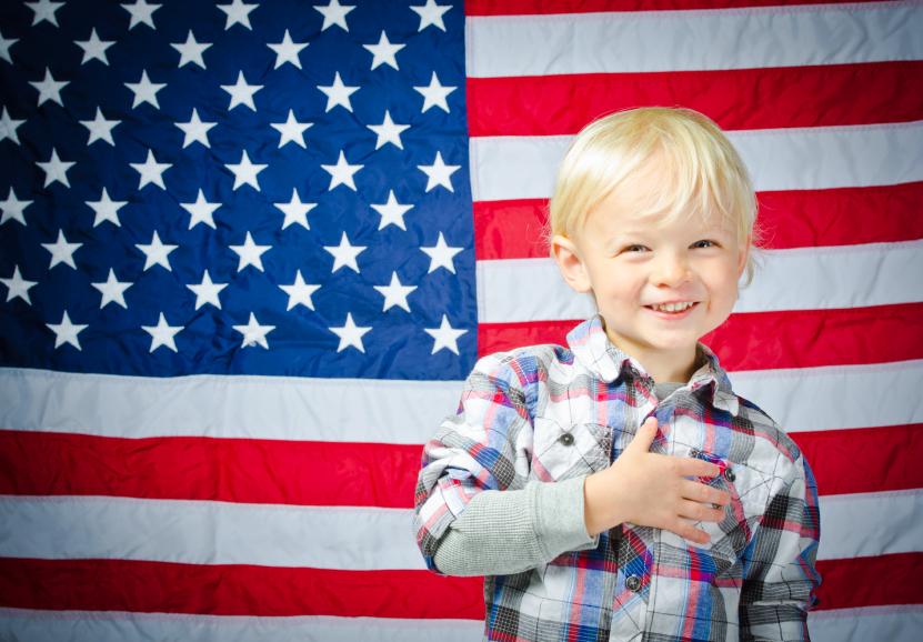 Boy in front of American flag